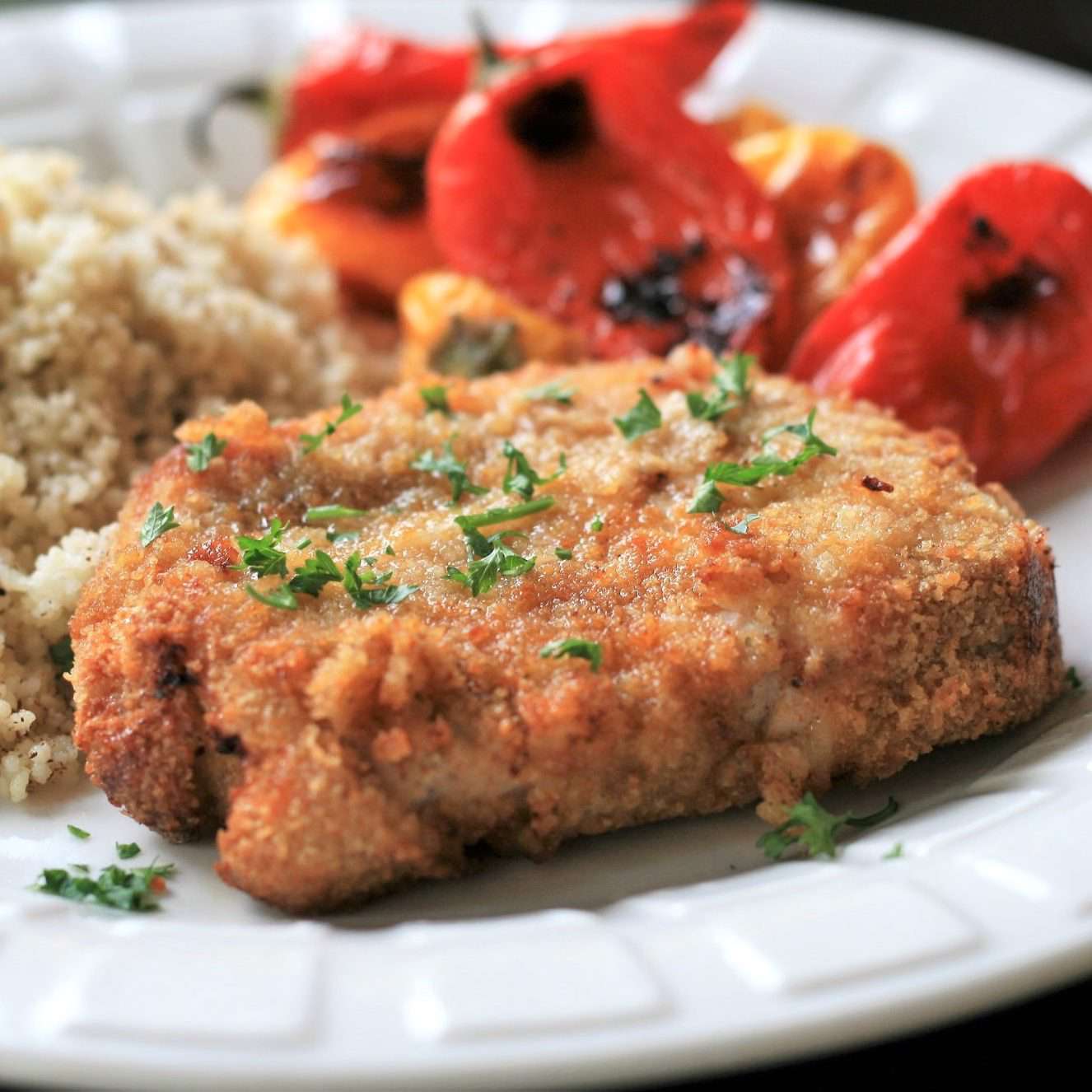 breaded pork chops with roasted peppers and couscous