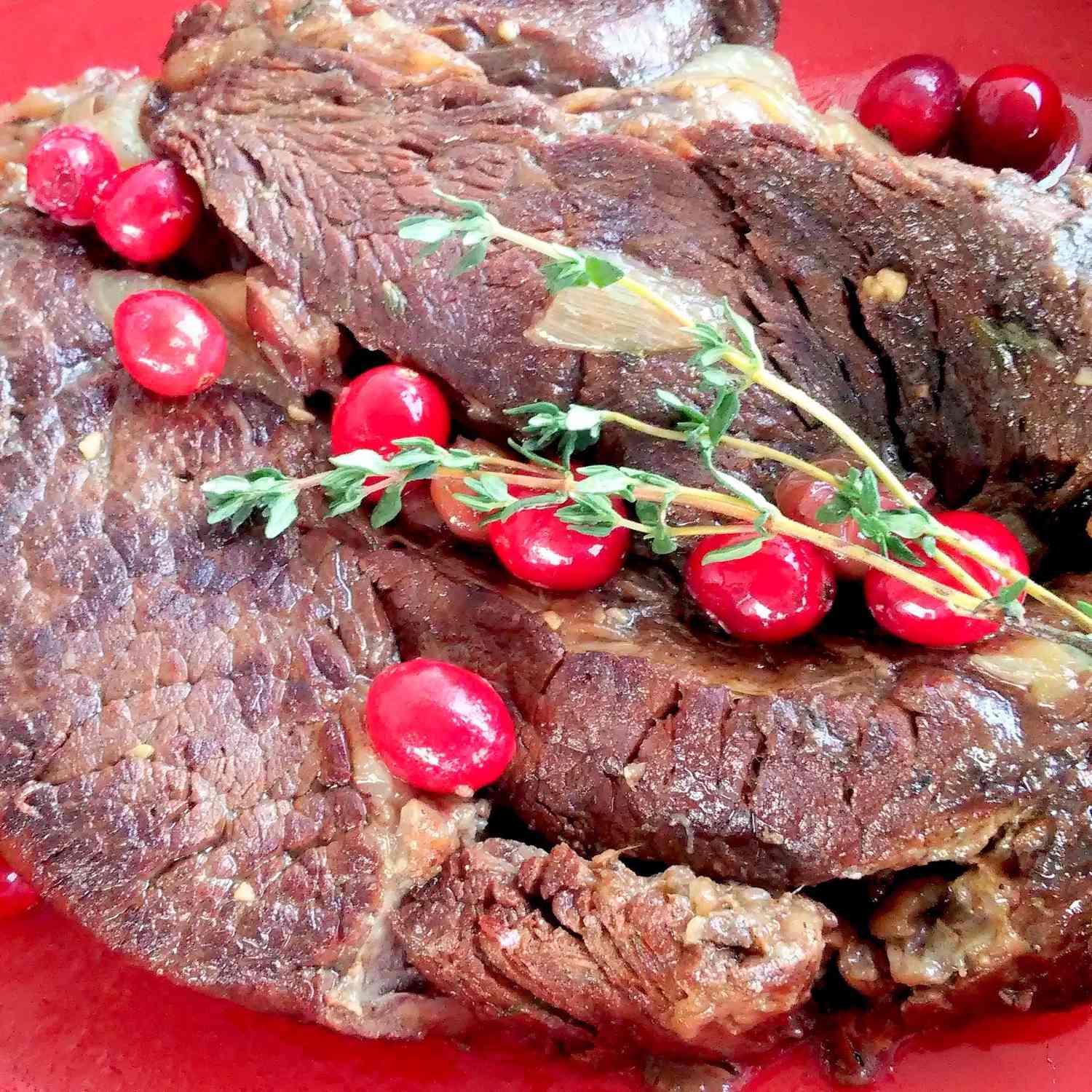 Cranberry-Thyme Pot Roast on a red dish