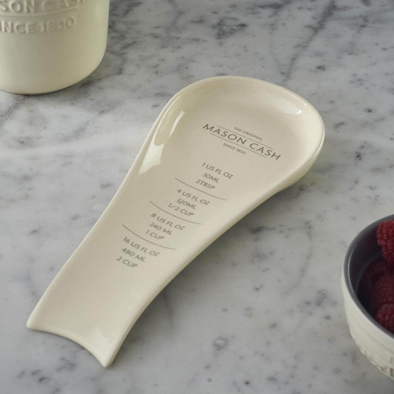white glazed spoon rest with measurement conversions printed on it