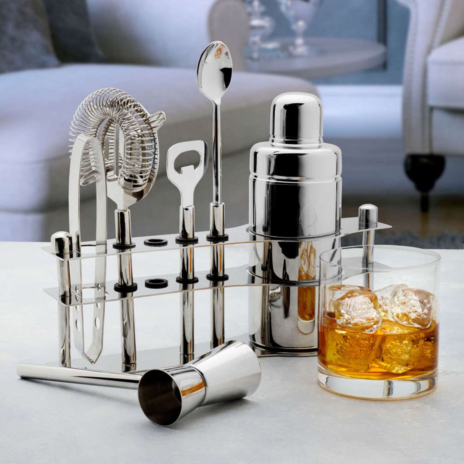 Mikasa Luxe 6-Piece Bar Tool Set with Stand next to a glass of bourbon