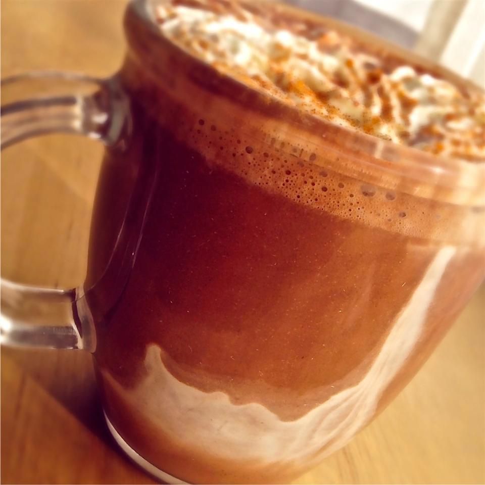 hot cocoa with whipped cream in a glass mug