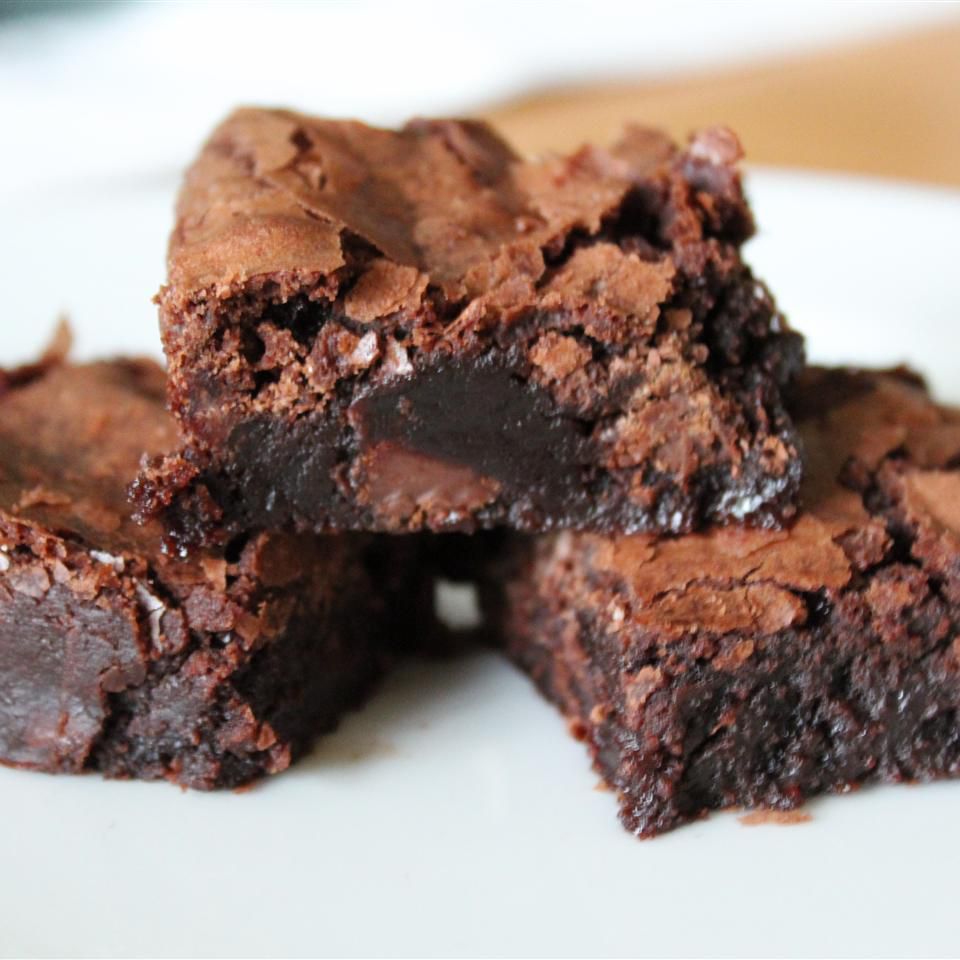 stack of three brownies on a white plate