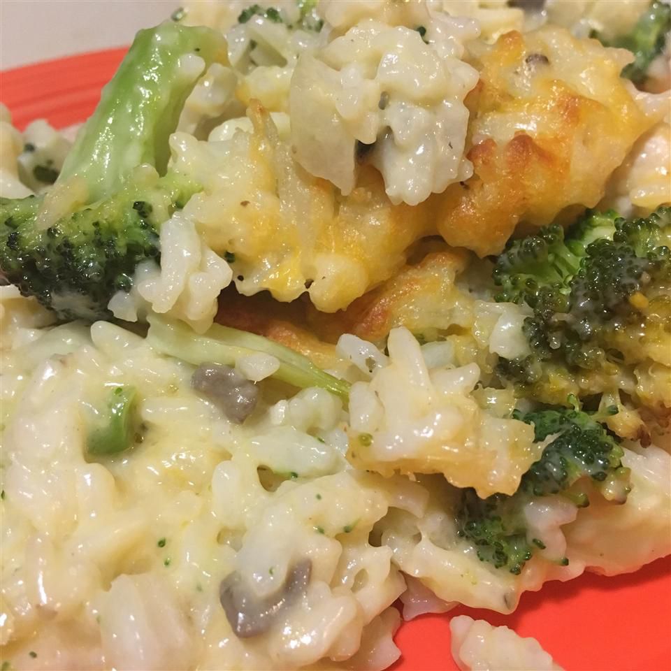 Broccoli, rice, chicken, and cheese casserole up close on red plate