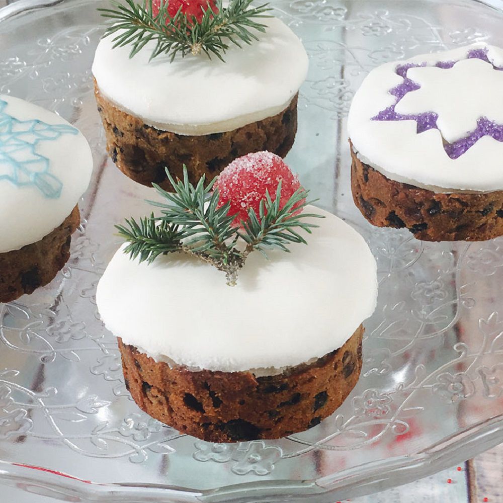 cupcake-sized fruitcakes decorated with smooth royal icing and snowflake designs