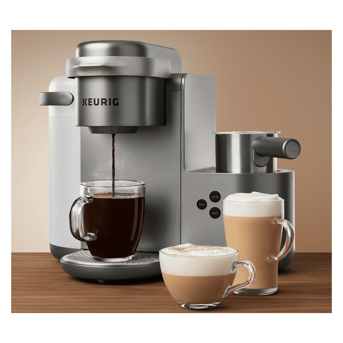 Keurig latte maker pouring coffee next to two prepared lattes