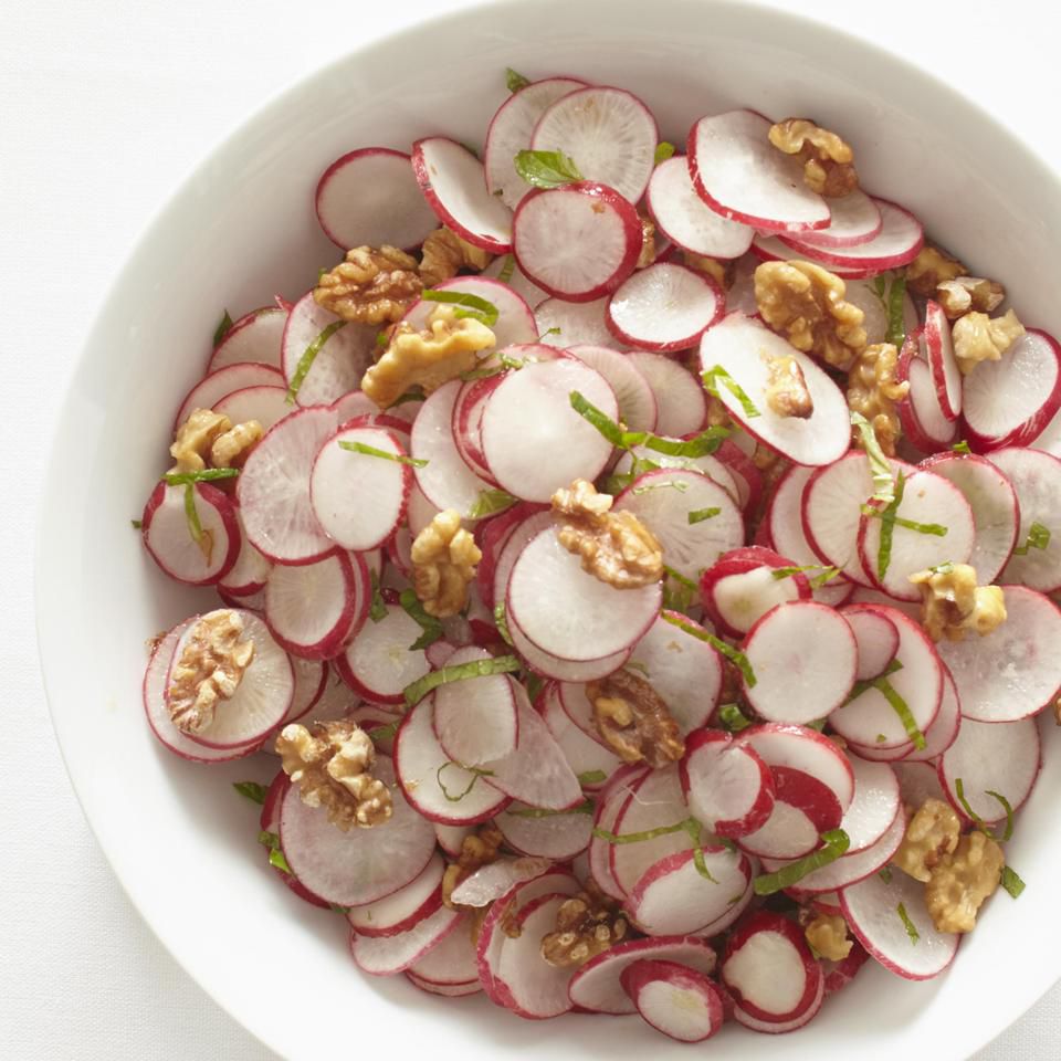 overhead shot of thinly sliced radish , walnuts and dill