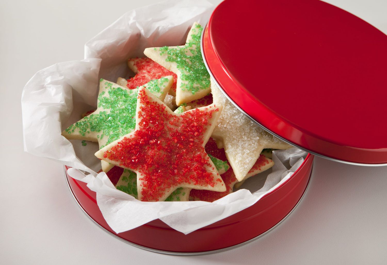 Star shaped sugar cookies in a red tin.