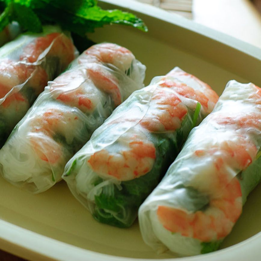 four spring rolls with shrimp on a plate