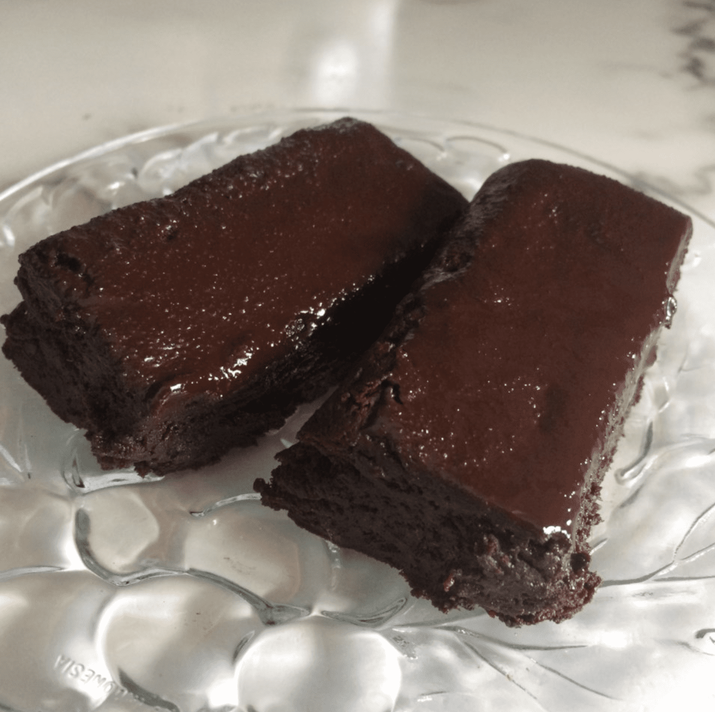 Vegan Cocoa Fudgy Gluten-Free Brownies on a glass plate