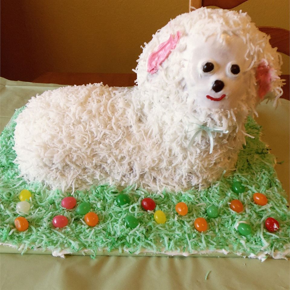 lamb shaped cake with coconut frosting and green coconut grass