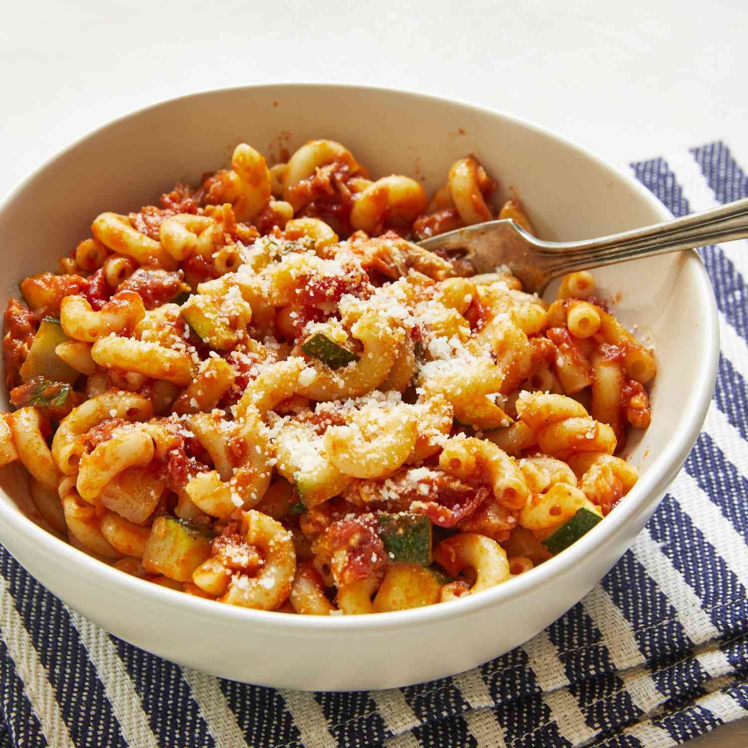 elbow pasta with zucchini and tuna in a red sauce
