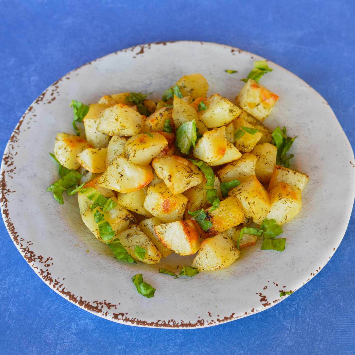 lemon roasted potatoes on earthenware plate