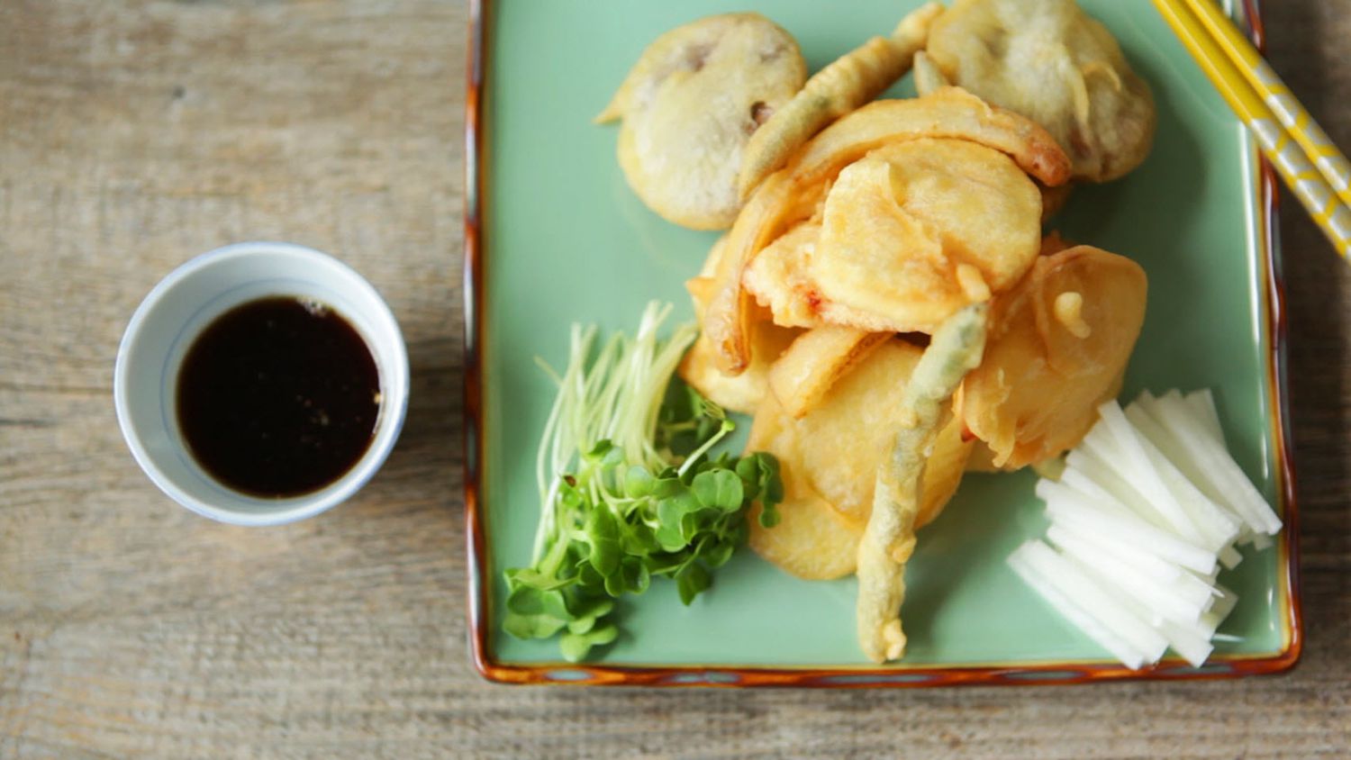 vegetable tempura on blue plate with soy sauce and chopsticks