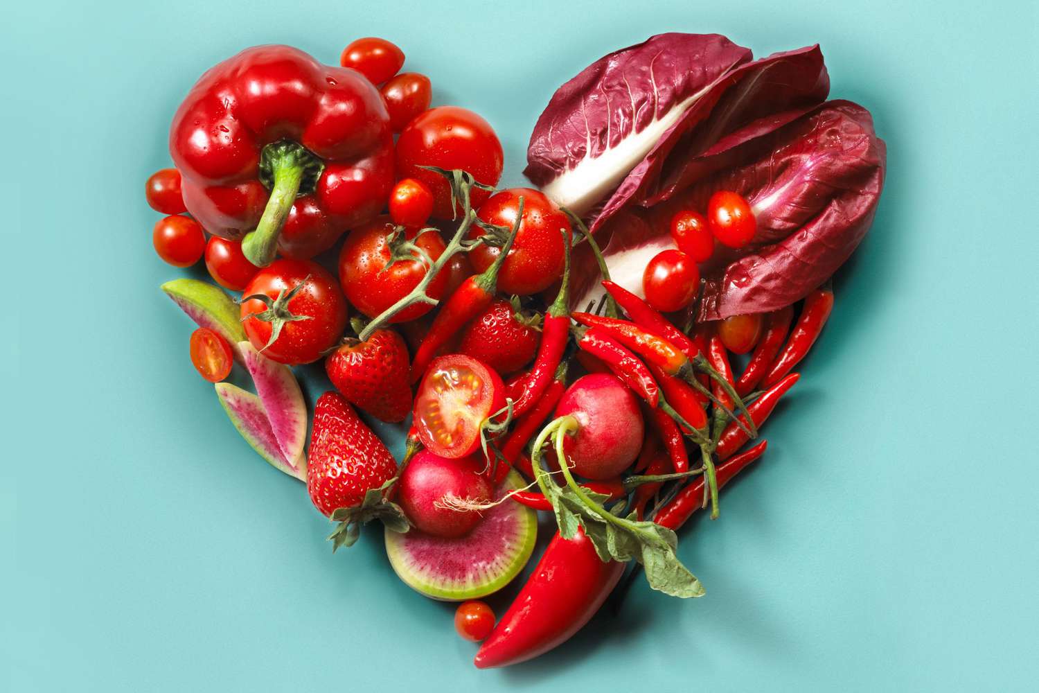 Red fruits and vegetables in the shape of a heart