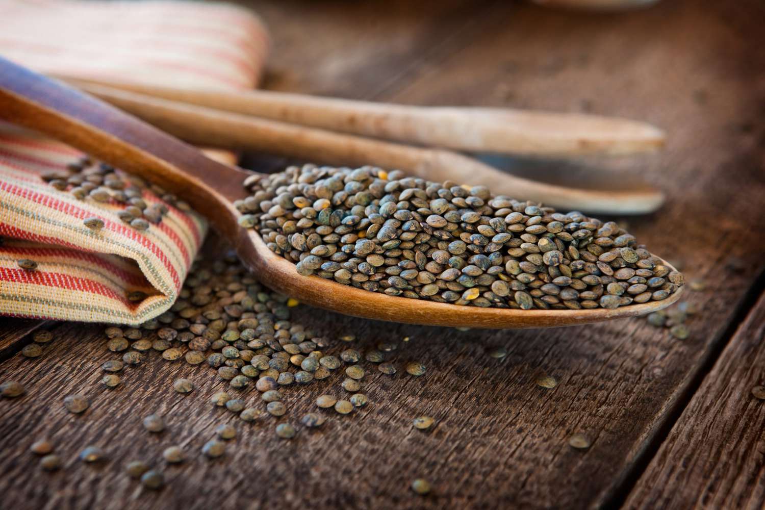 French lentils in a wooden spoon