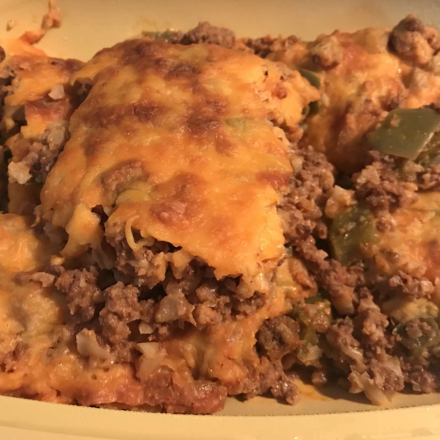 rice and ground meat casserole with cheese on top