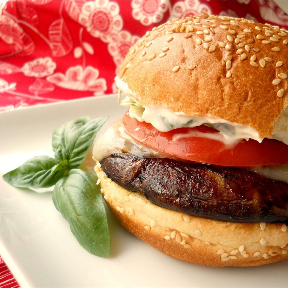 Grilled Portobello with Basil Mayonnaise Sandwich on a white plate
