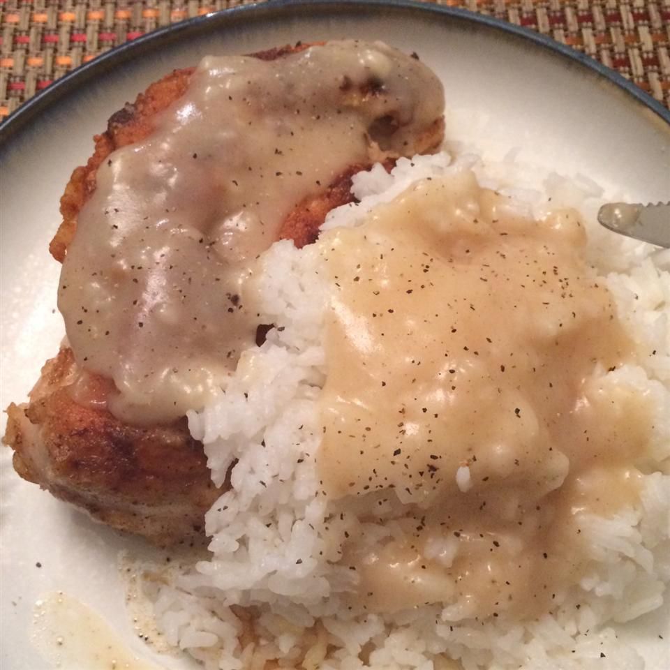 Chicken with Rice and Gravy on a white plate