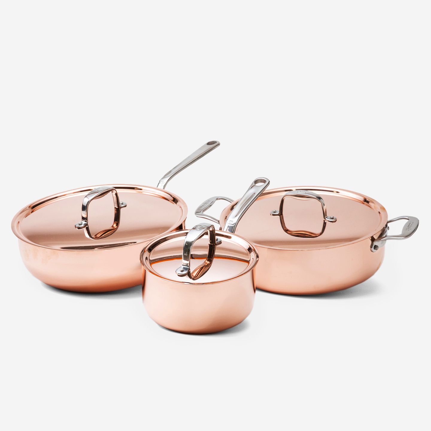 Three copper cookware pots with stainless steel handles