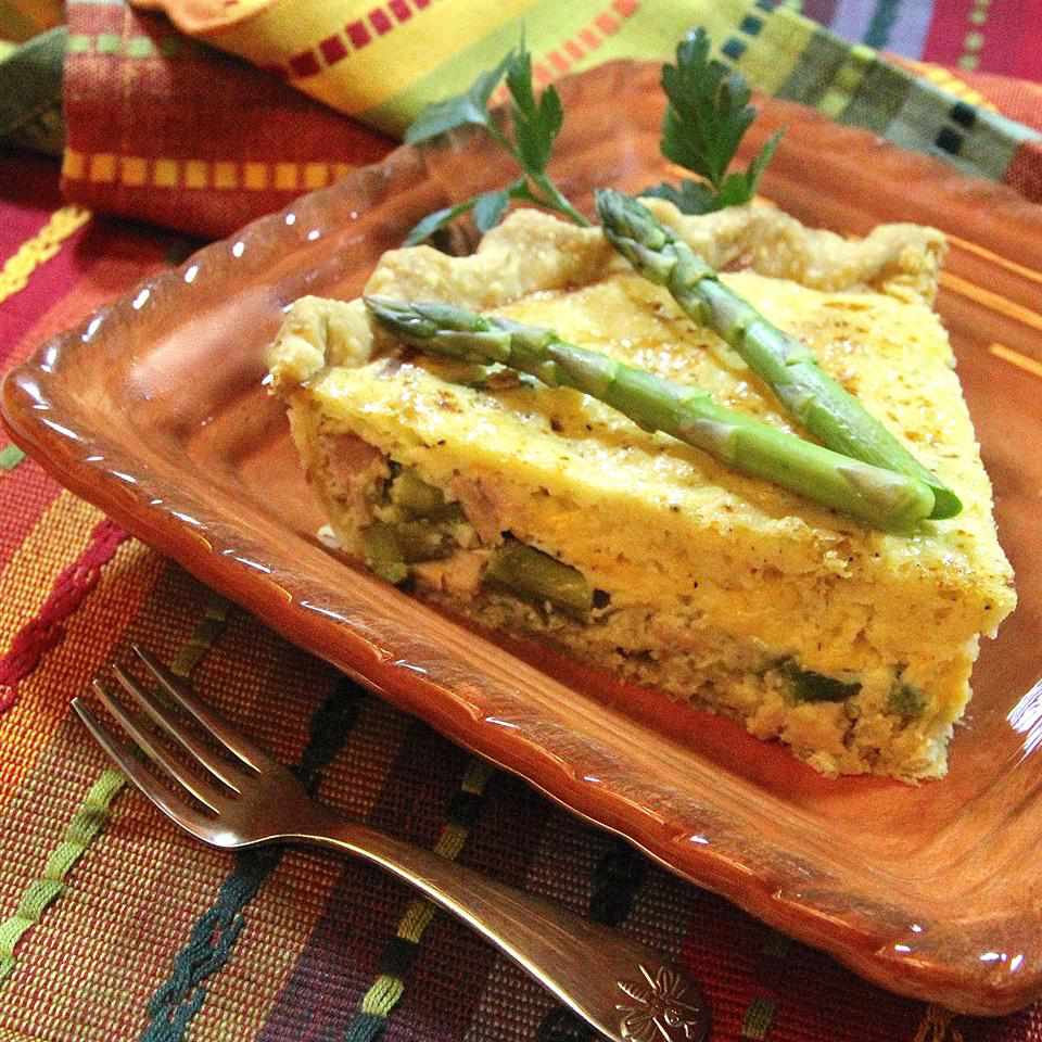 quiche with asparagus on an orange plate