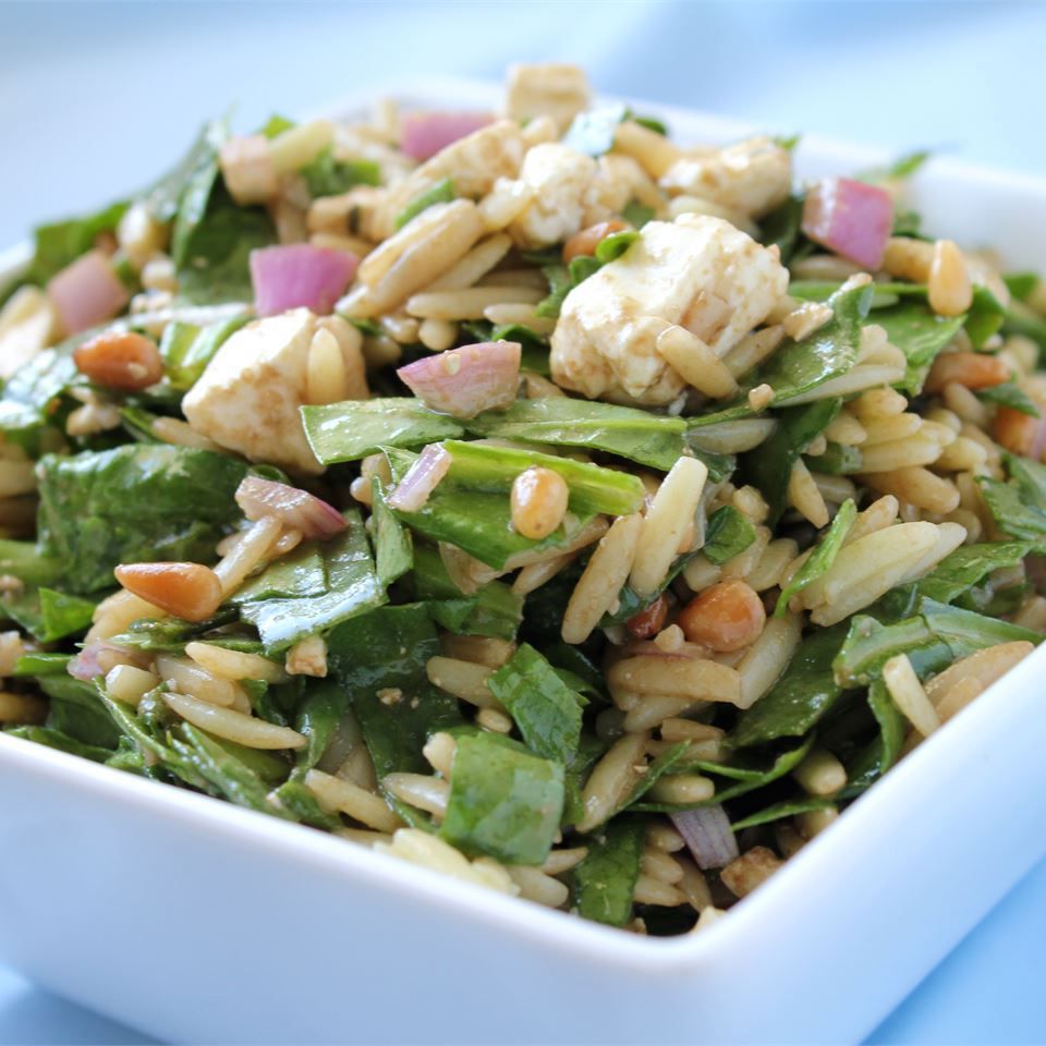 spinach, orzo, feta salad in.a white dish