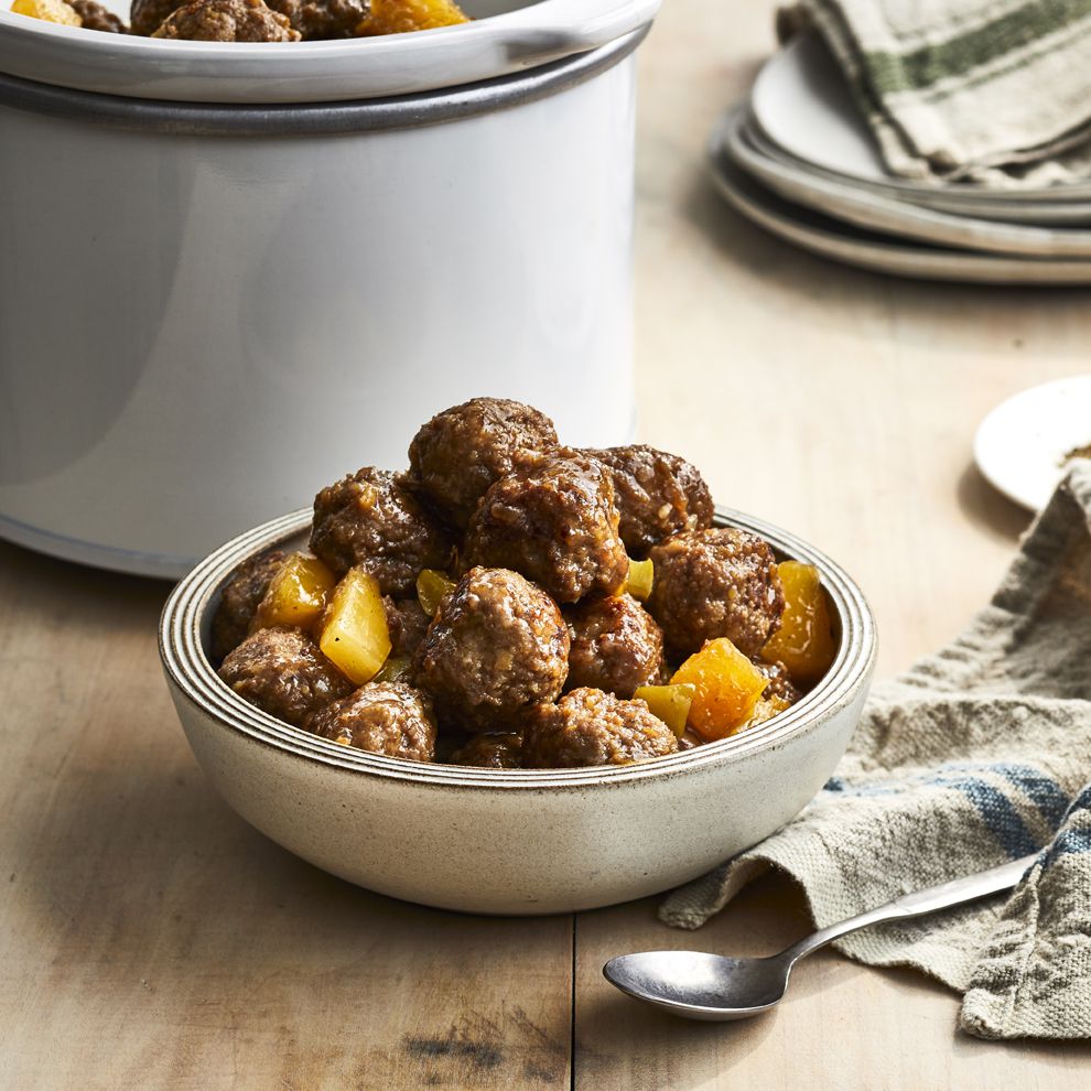 Bowl of Steph's Zesty Sweet and Sour Meatballs with a slow cooker in the background