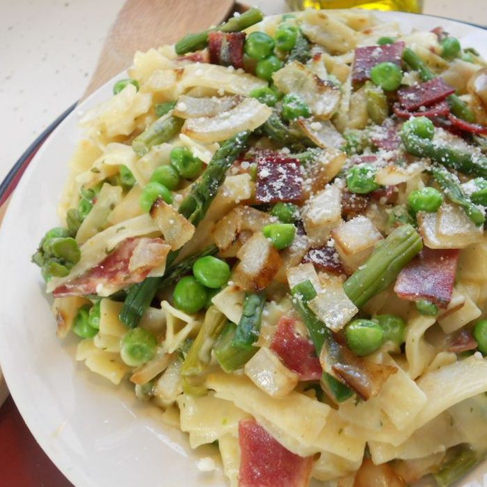 dish of pasta with asparagus, peas, and bacon