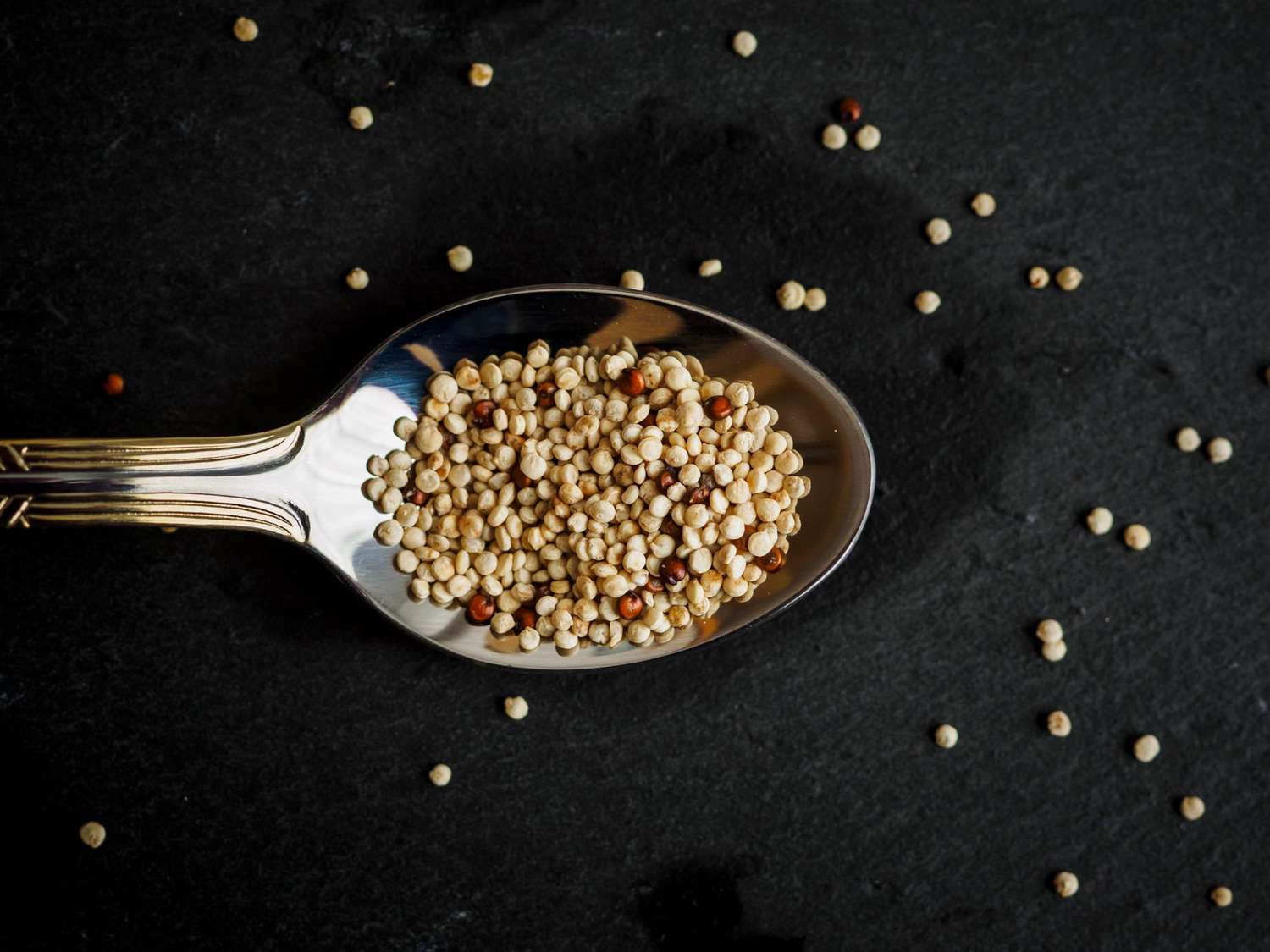 quinoa in a spoon on a dark background