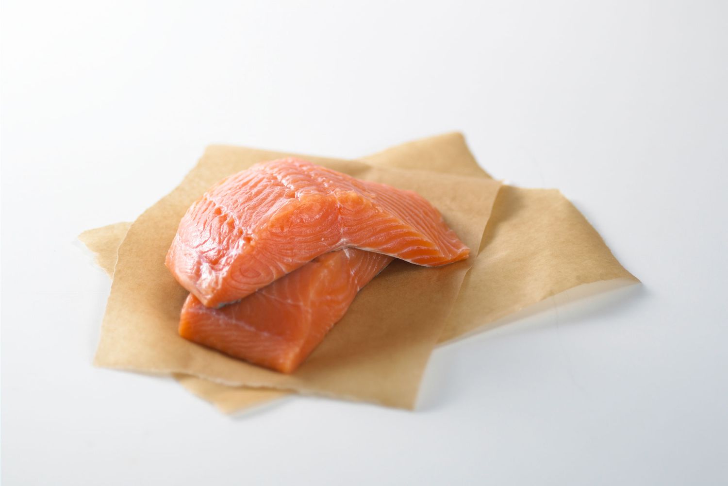 salmon fillets on parchment paper