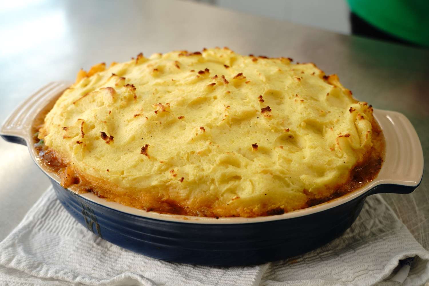 homemade shepherd's pie topped with mashed potatoes in a casserole dish