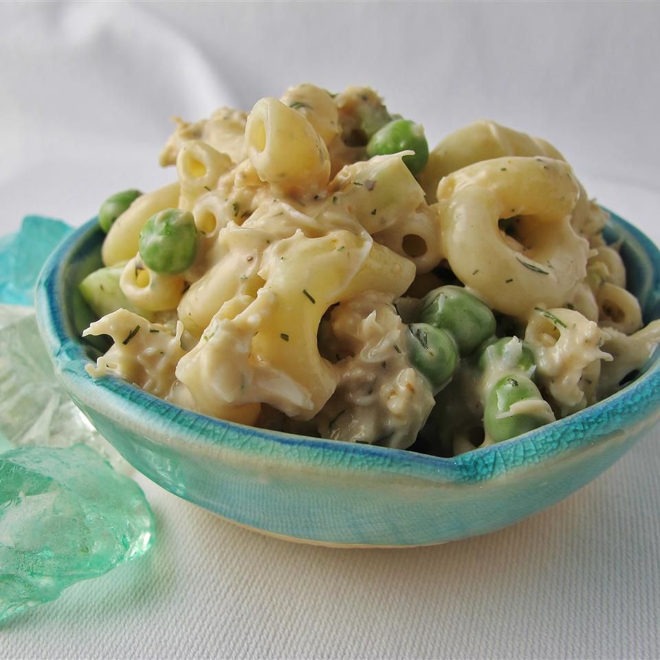 macaroni salad with crab meat and peas in blue bowl