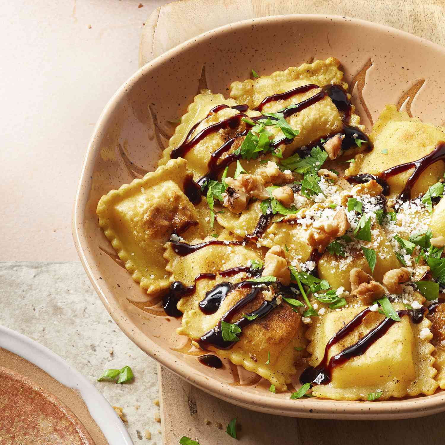 bowl of ravioli drizzled with a balsamic reduction