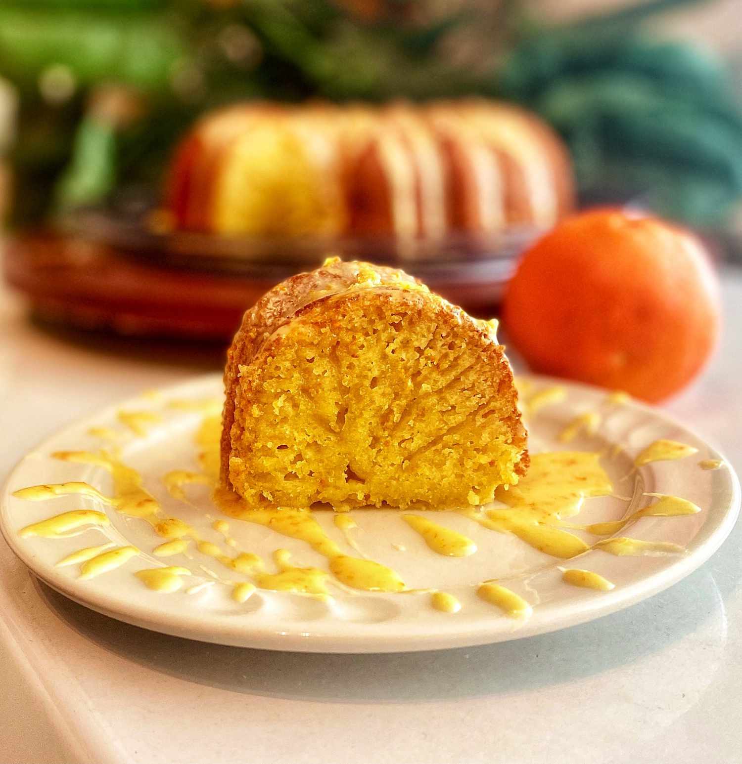 Easy Orange Ricotta Cake slice on a plate with drizzle