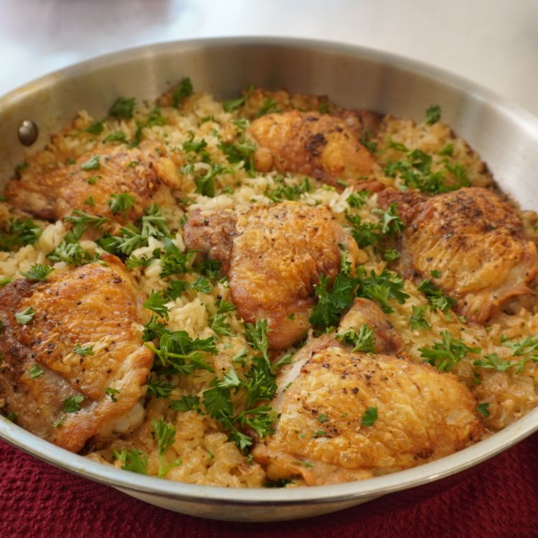chicken thighs and rice baked in a pan