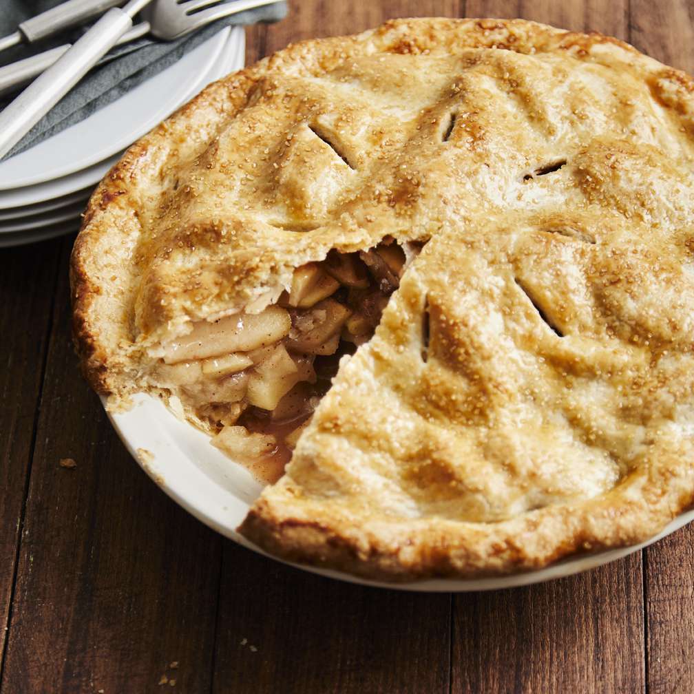 Golden brown salted caramel apple pie with slice out