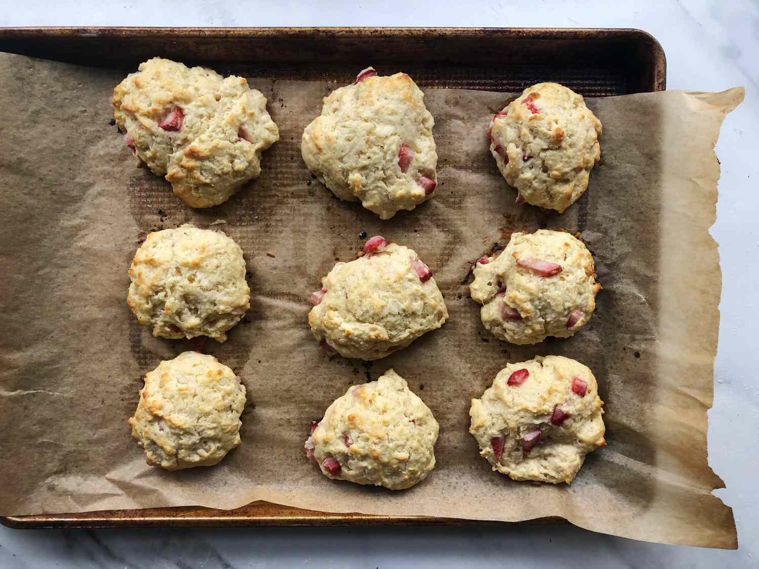 baked strawberry drop biscuits on baking sheet