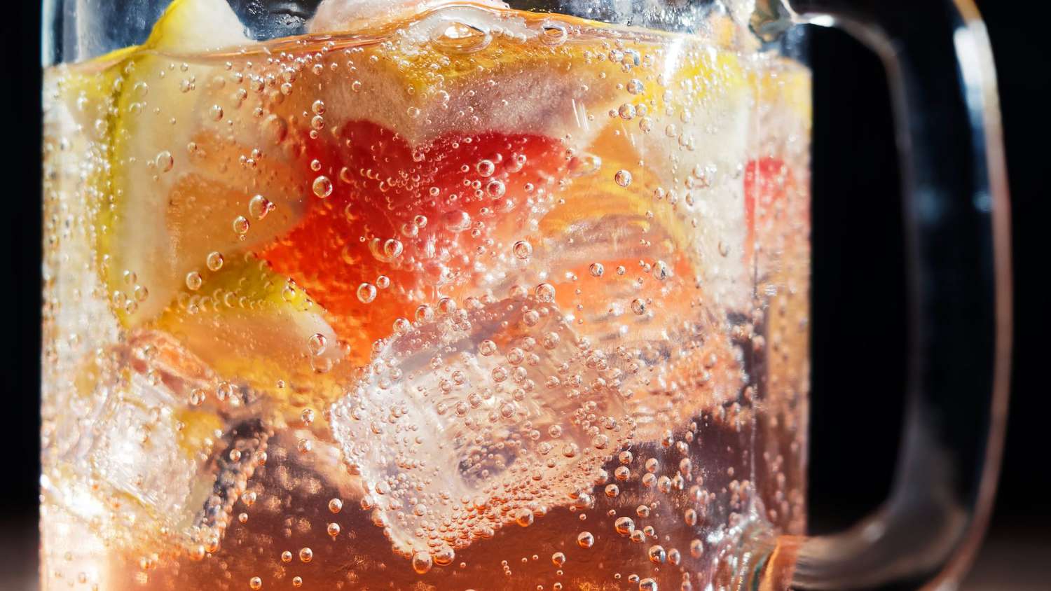 sparkling water with grapefruit and lemon slices and ice cubes