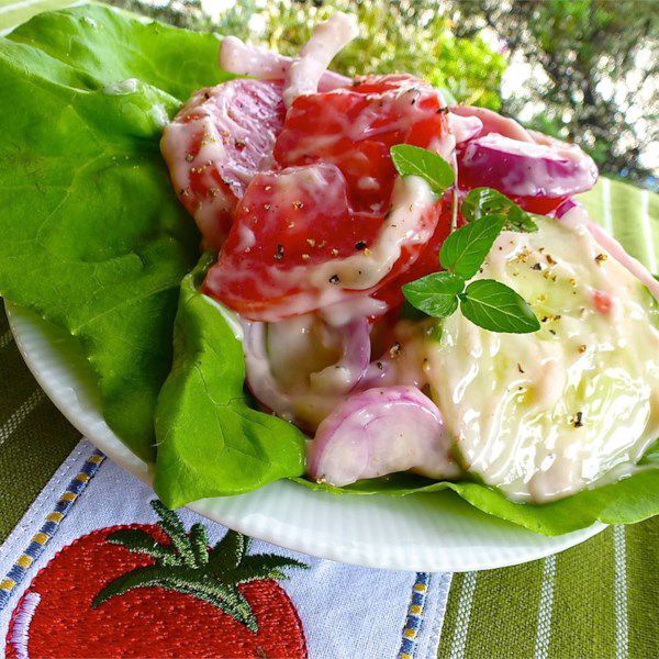 creamy cucumber and tomato salad on butter lettuce with herbs