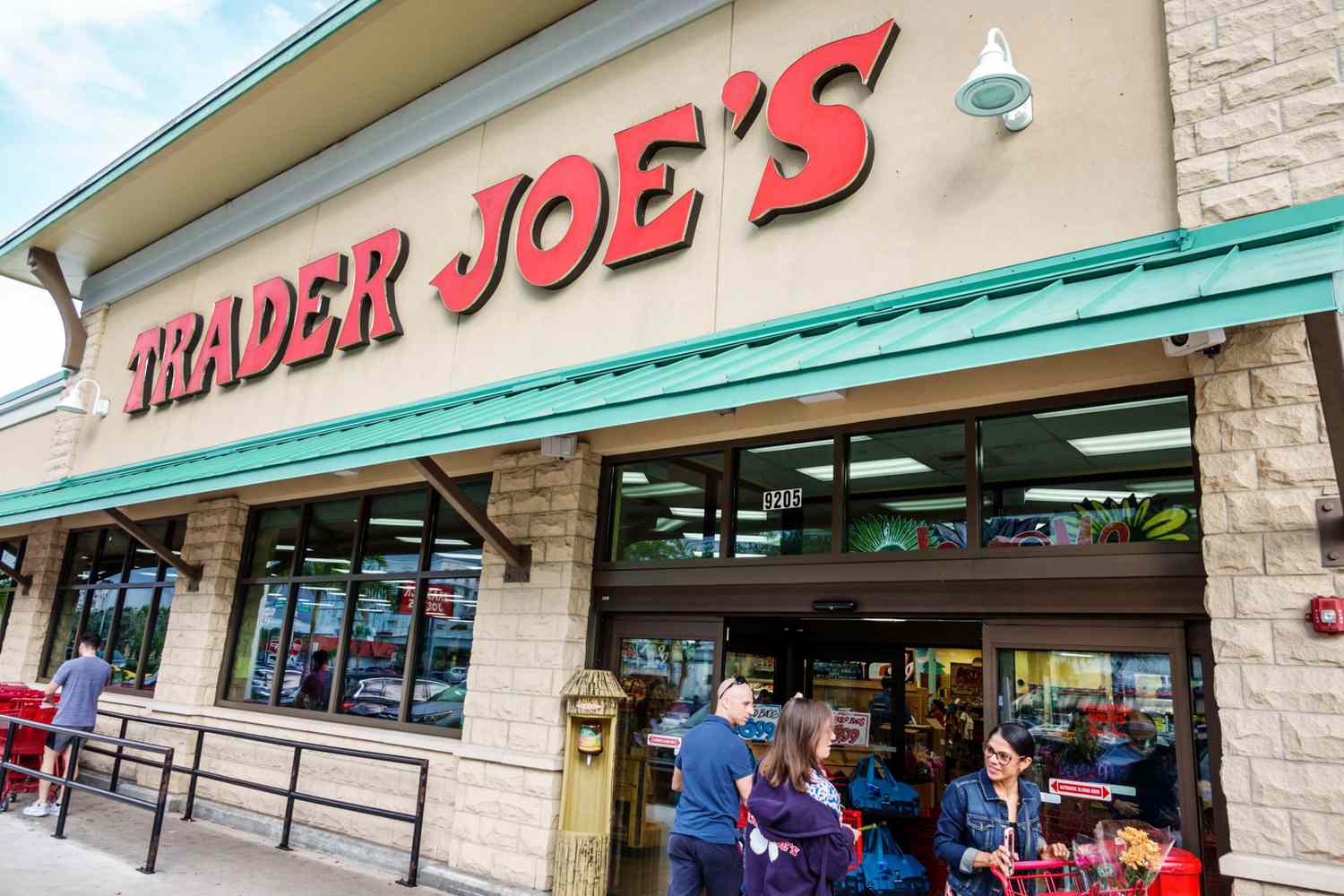people standing in front of a trader joe's store