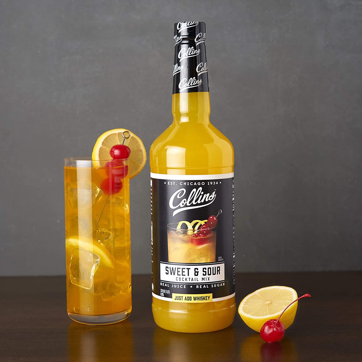 bottle of sweet and sour cocktail mix next to cocktail