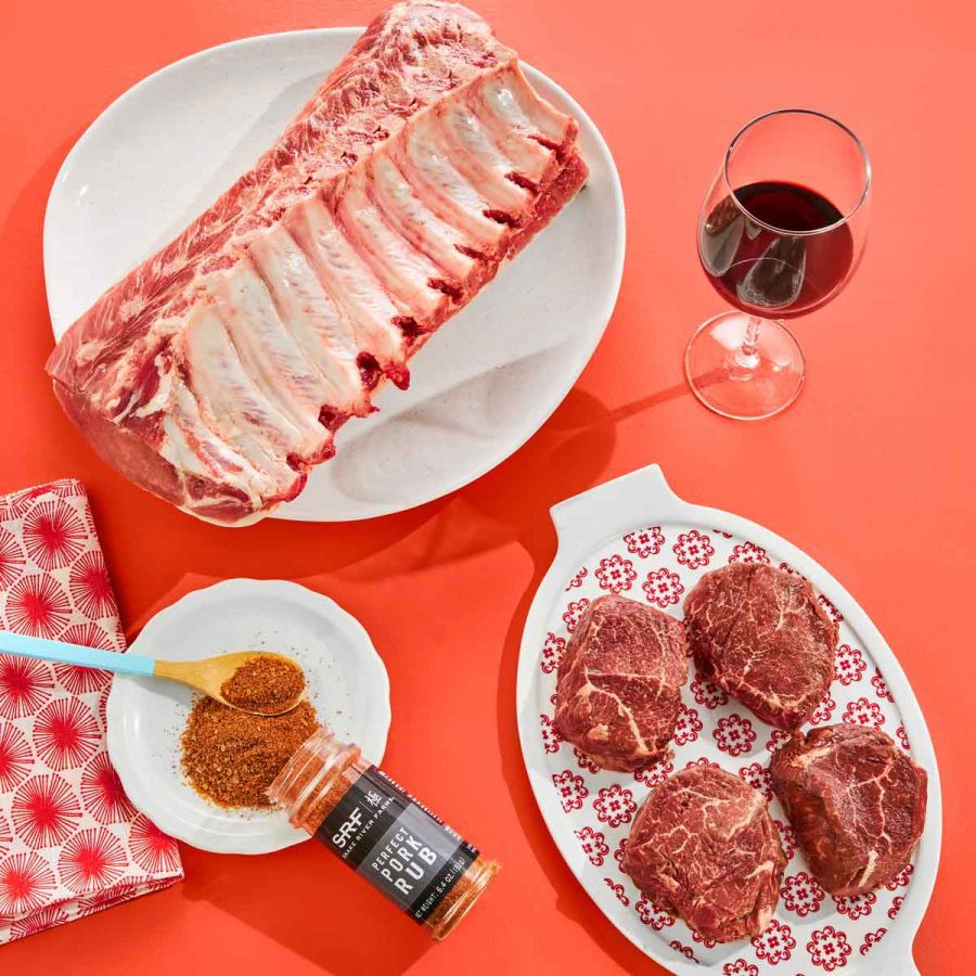 ribs, hamburger, and steaks on platters