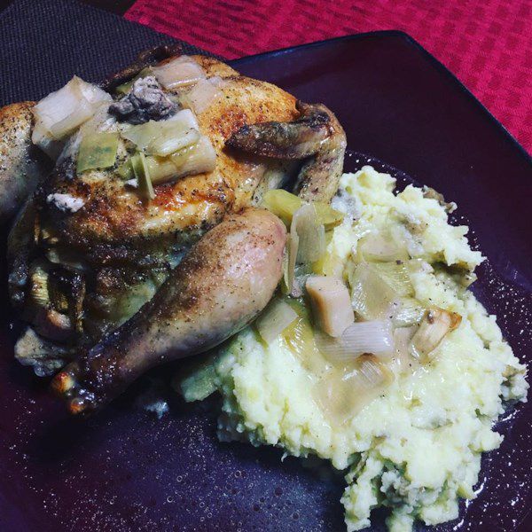 lemon and leek cornish hen on a plate with mashed potatoes