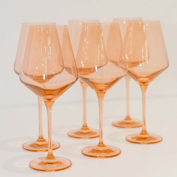 peach-colored stemmed wine glasses