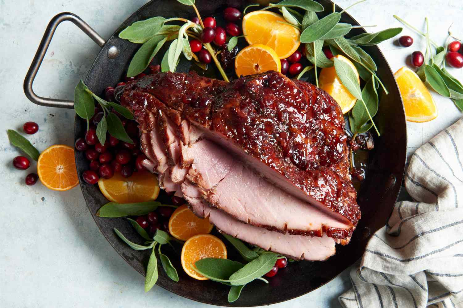 holiday glazed ham in pan with cranberries and oranges
