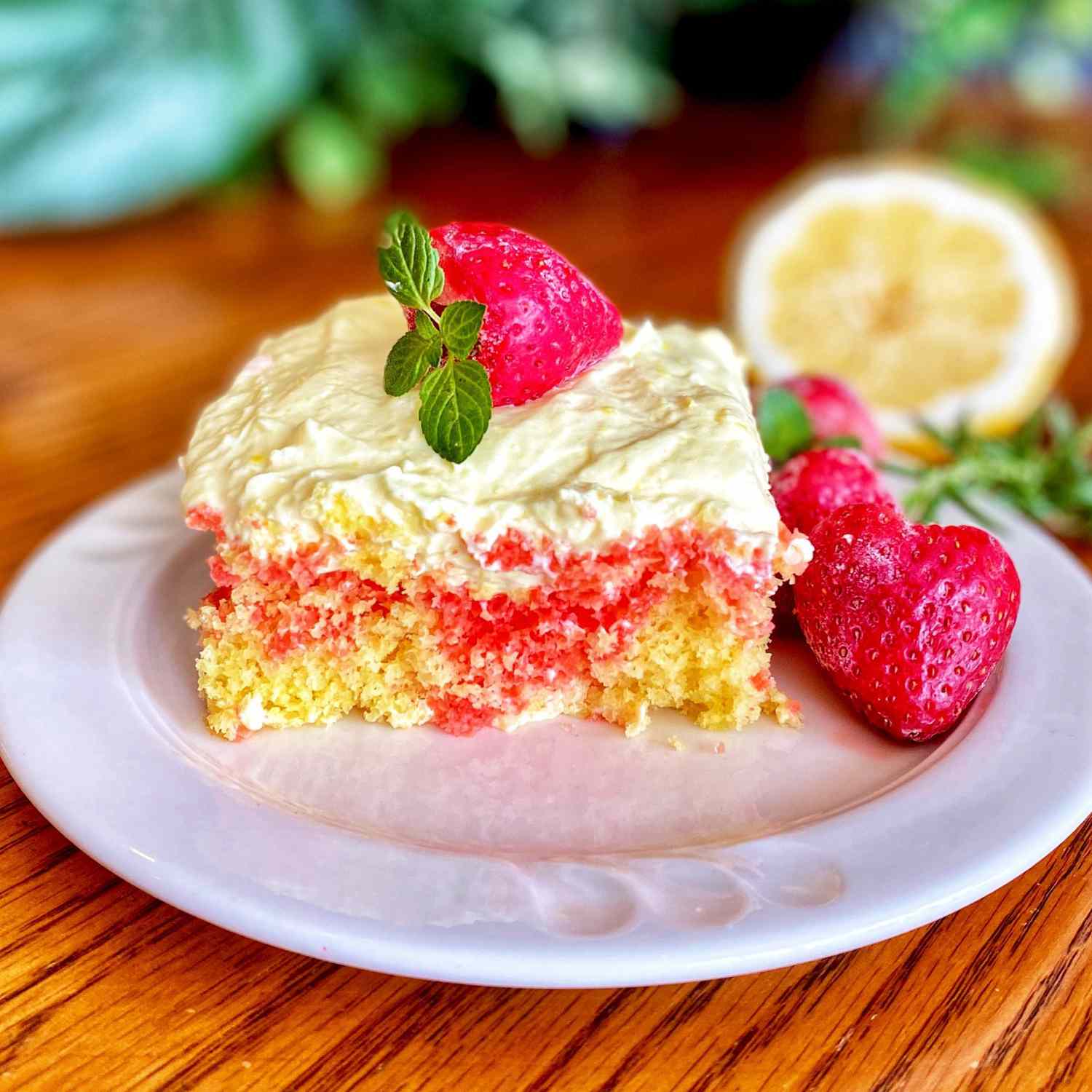 a square slice of strawberry lemonade poke cake