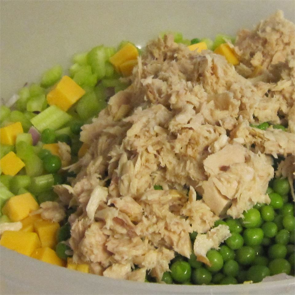 canned tuna with celery, cheese, and peas for a tuna macaroni salad