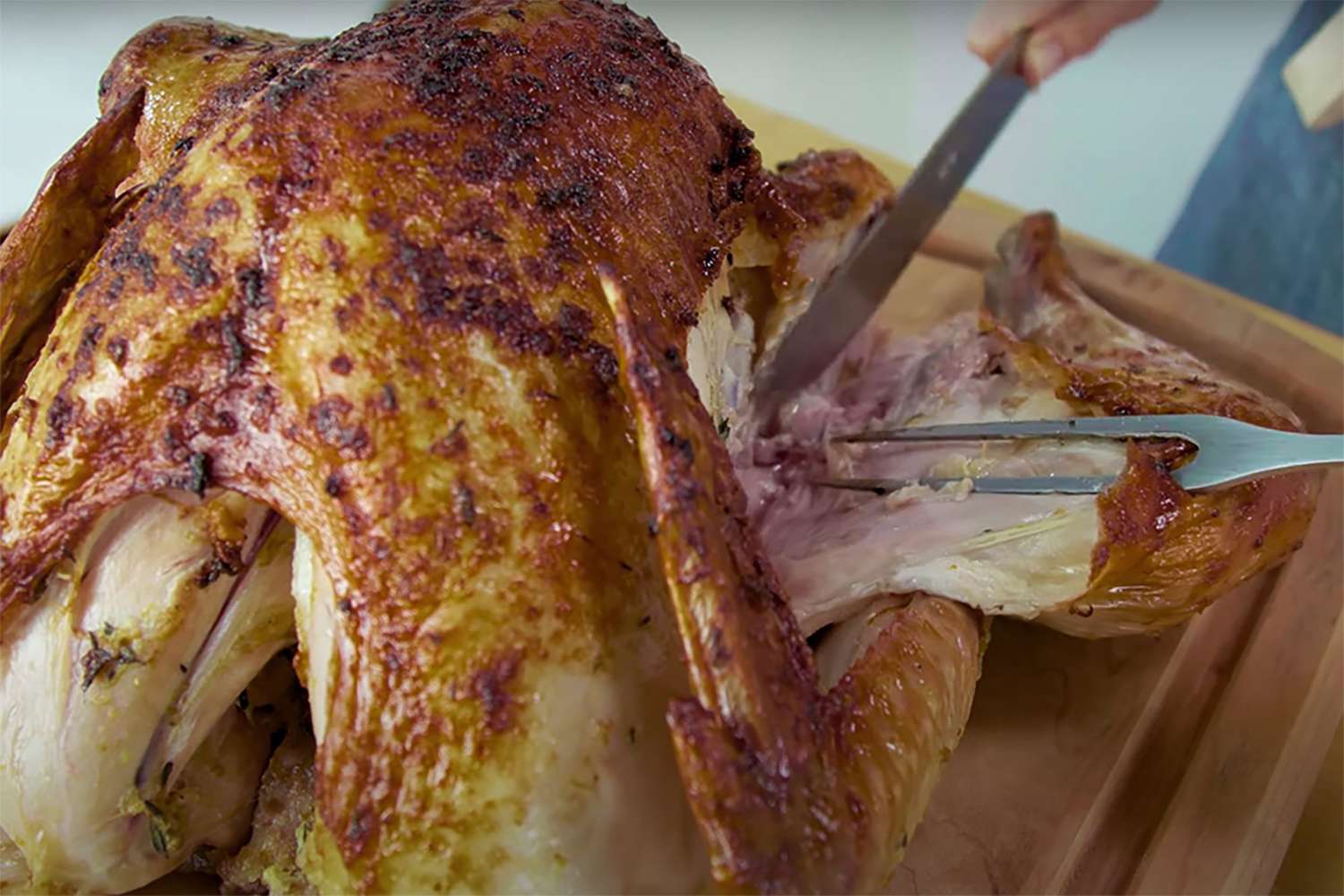 using carving knife and fork to remove turkey leg