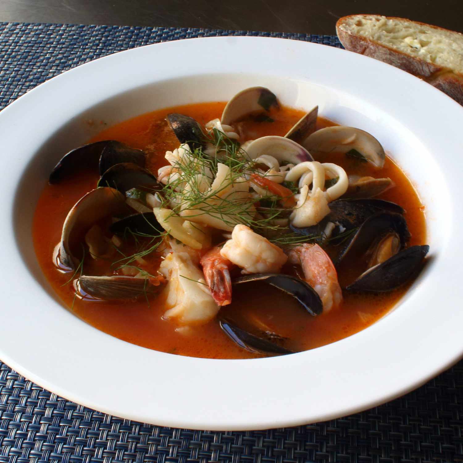 tomato based stew with clams, shrimp, calamari, fish
