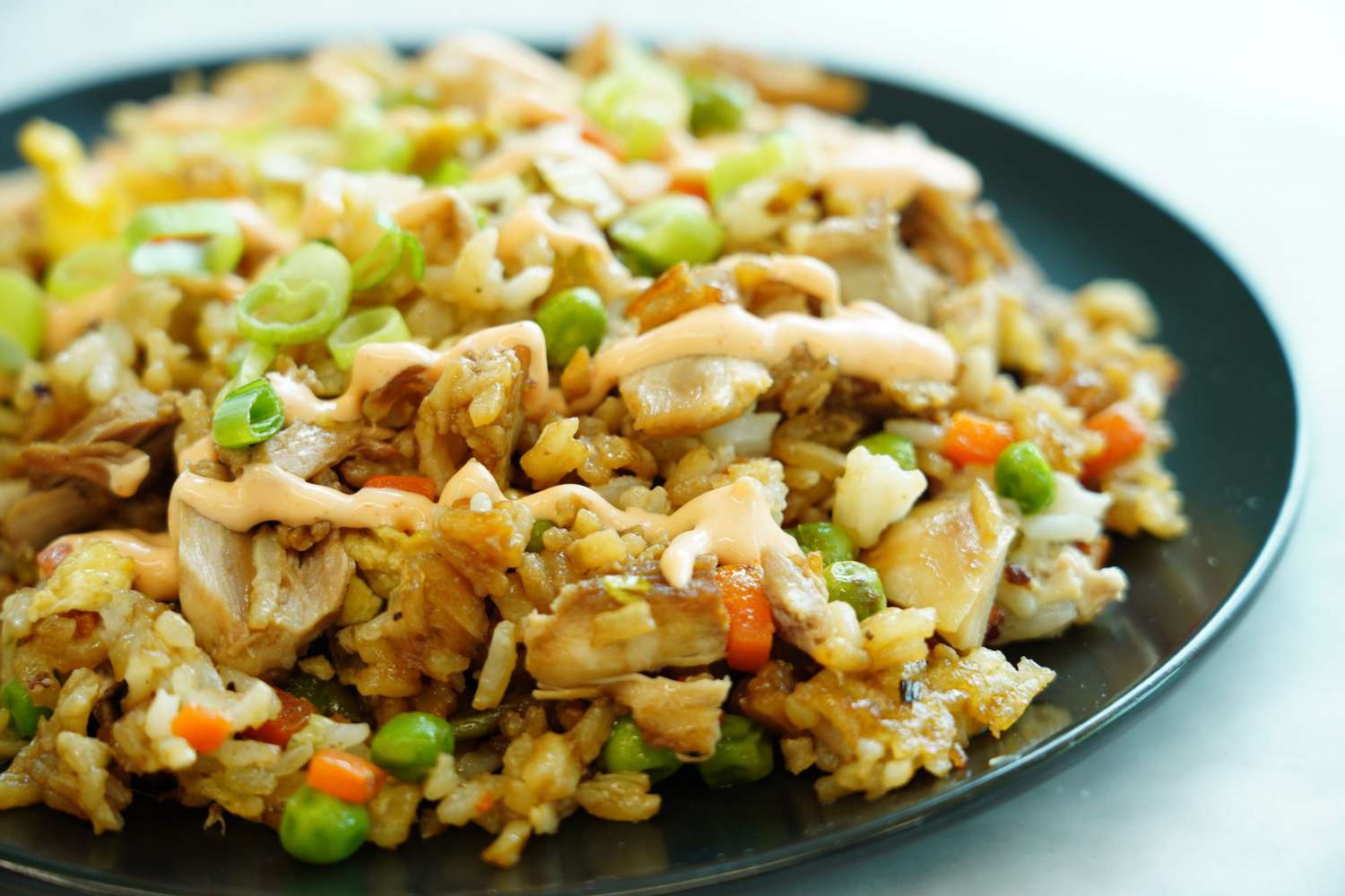 close up on dish of Easy One-Pan Chicken Fried Rice with peas and carrots