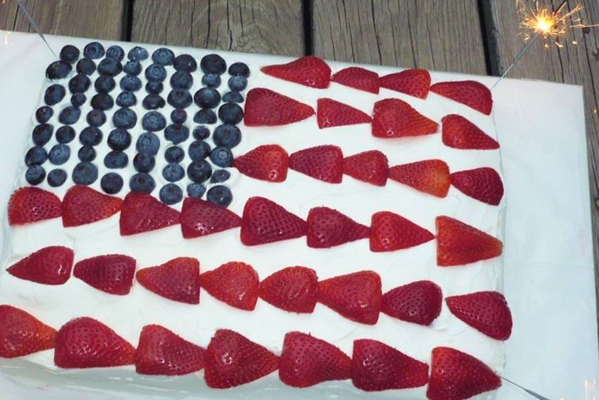 a flag cake with berries as the stars and stripes
